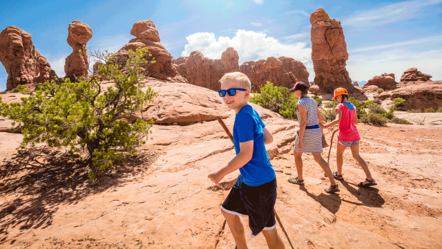 family on a hike through Arches National Park