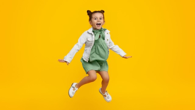 a girl jumps against a yellow background at an indoor playground Atlanta kids and families flock to on a rainy day