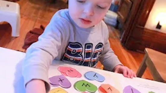 a picture of a boy playing a Valentine's Day game