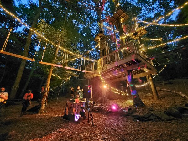 zipline course lit up by twinkle lights at night near NYC