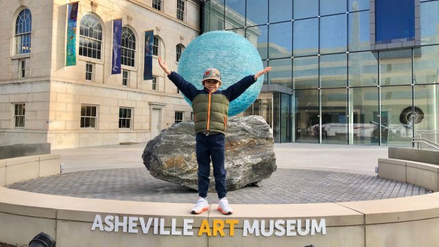 kid in front of asheville art museum