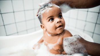 father using natural skin care products on his baby
