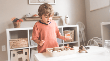 little boy in a Montessori Playroom