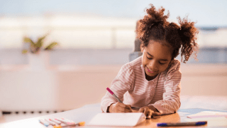 little girl doing mathwork sheets for kids