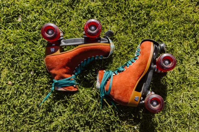a pair of retro rollerskates in grass