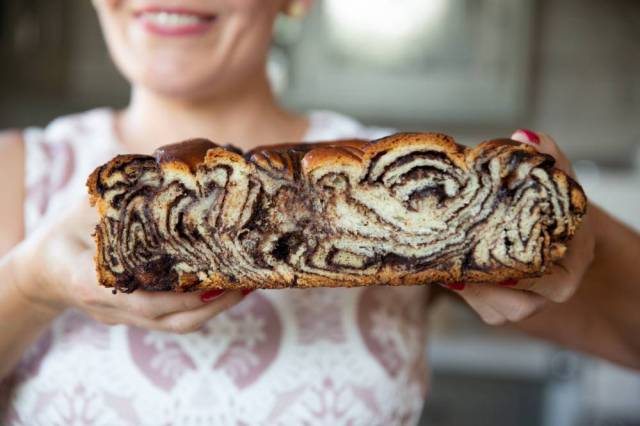 Woman holds a chocolate brioche