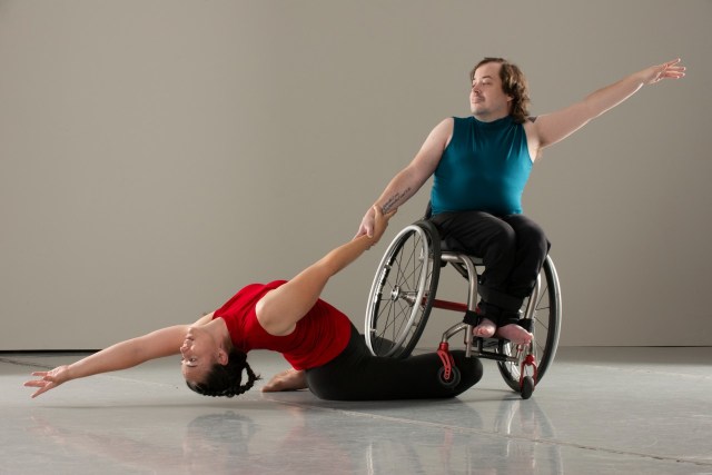 A man in a wheelchair dancing with a woman 