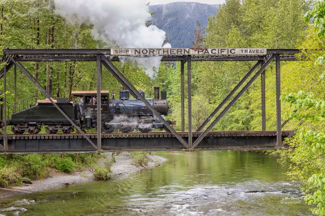 A steam train crosses the Snoqualmie Valley River as a special Mother's Day activities in seattle