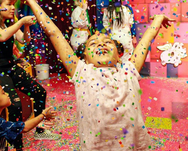 girl throwing confetti at Candytopia