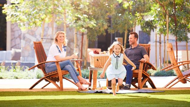 A family relaxes on the Village green at the Vista Collina in Napa