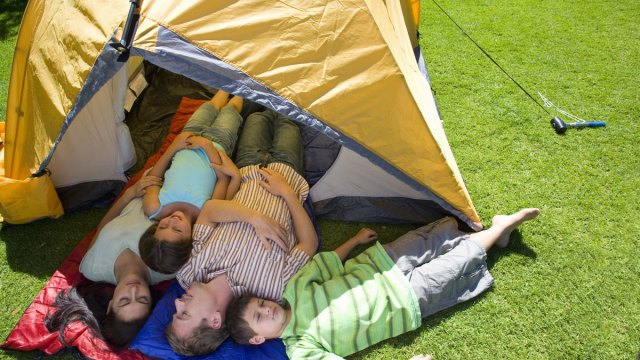 A fun family activity in summer, this family is camping in the backyard