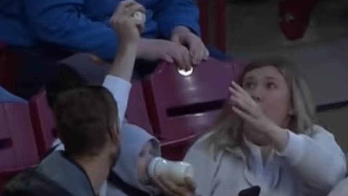 Fan makes incredible catch on foul ball while bottle feeding baby