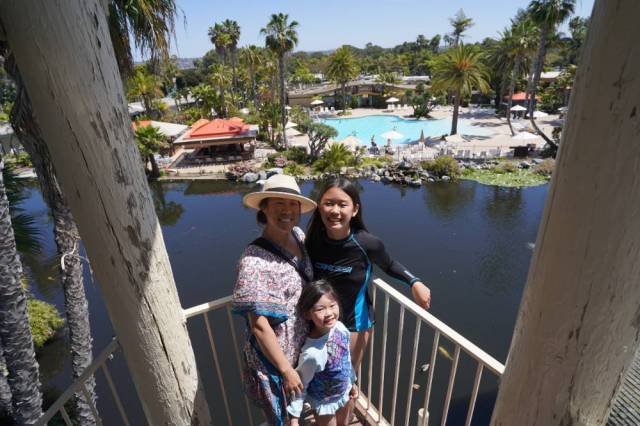 A mom and two kids stand on an observation tower in Mission Bay