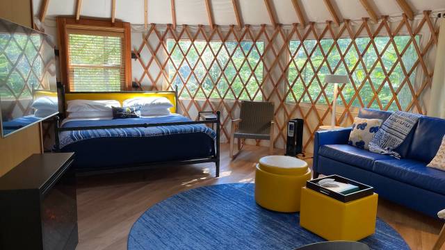 Yurt bedroom and living room with blue furniture