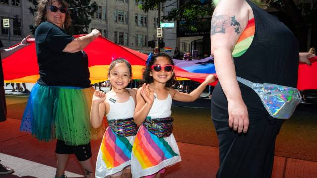 moms march with their kids during seattle pride parade activities and events