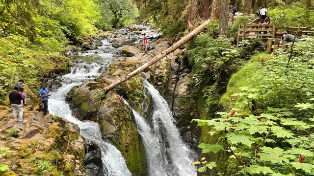 people line the sides of seattle waterfall hikes at sol duc falls