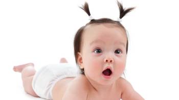 baby with ponytails making a surprised expression - money-saving tips