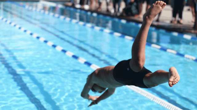 a boy diving into a pool. swimming pool games