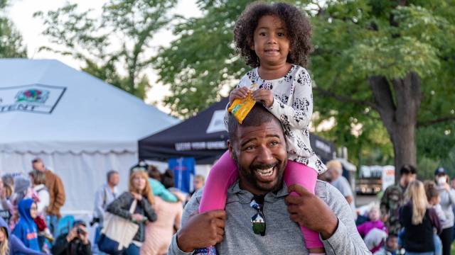 a dad and daughter at a festival fathers day