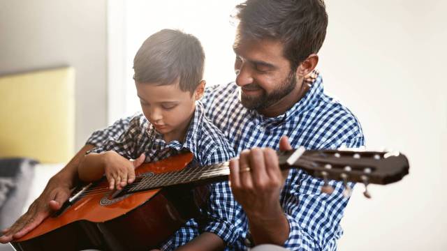 a dad and son play guitar father's day