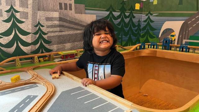 a smiling boy at kidsquest museum on free or cheap museum days seattle