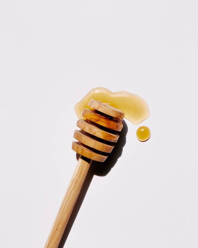 honey with wooden dipper - new mom beauty tips
