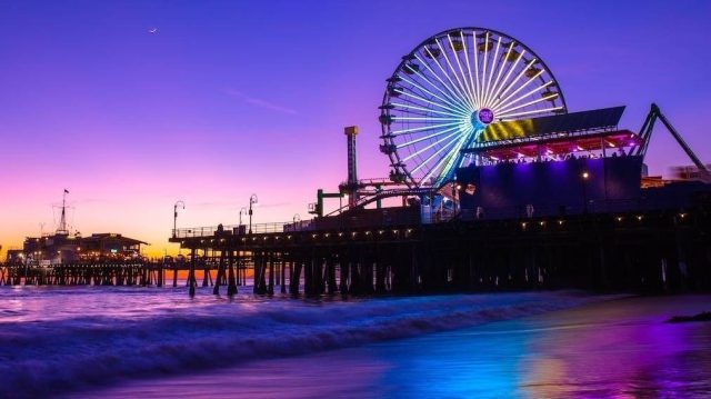 Santa Monica pier at night with view of the Ferris wheel and shoreline