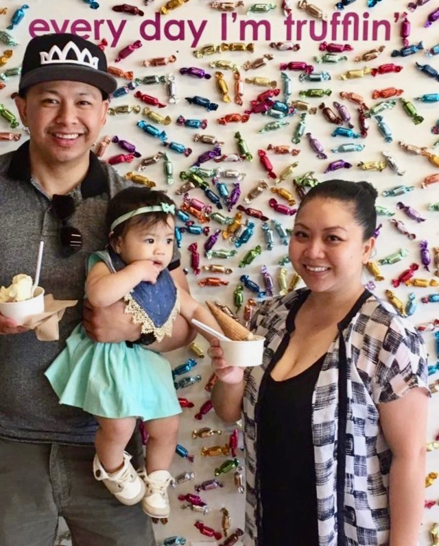a family poses in front of Seattle Chocolate truffle wall murals in seattle