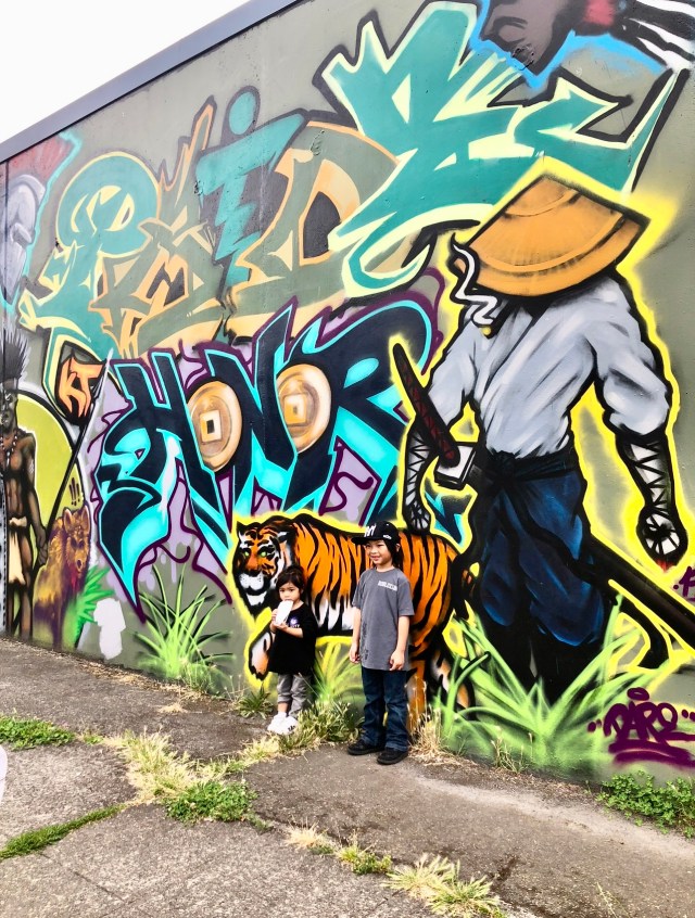 coloful animals are part of this wall murals in seattle art