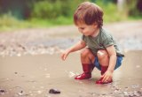 happy kid playing in a puddle