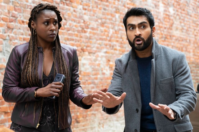 Issa Rae and Kumail Nanjiana as Jibran of "The Lovebirds" from NETFLIX stand in front of a brick wall