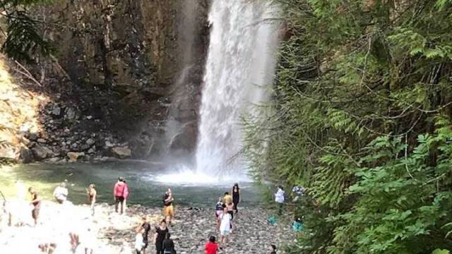 People gather at the base of Franklin Falls, a seattle waterfall hike