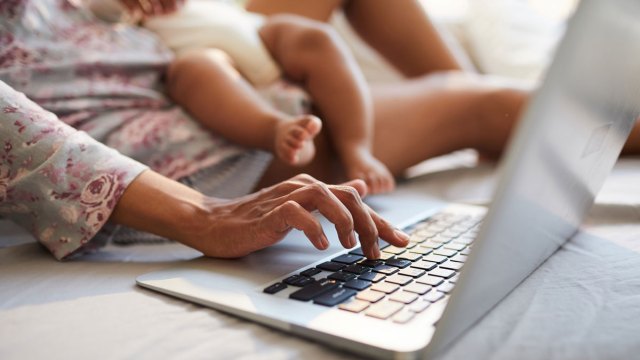 woman with newborn on laptop