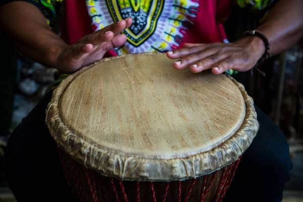 a pair of hands plays the African drums