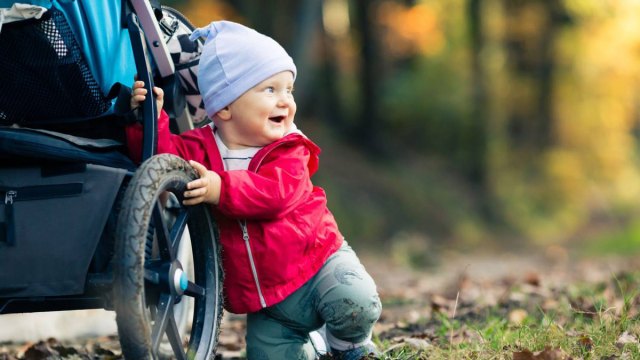 baby smiling with stroller