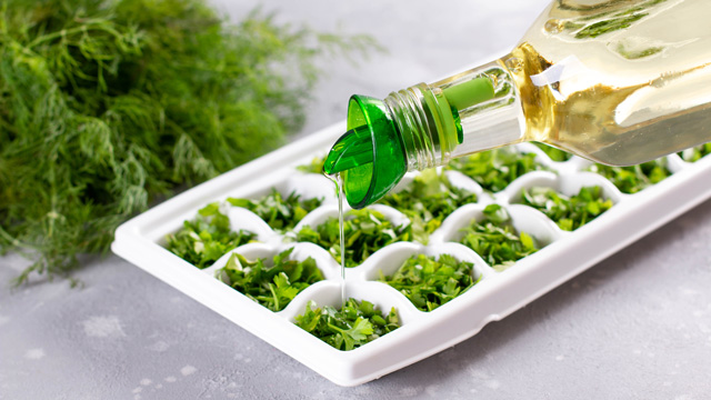 freezing herbs in an ice tray is a good cooking hack to use