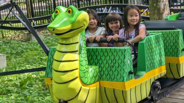 3 girls riding dragon coaster at fantasy forest amusement park in flushing meadows park