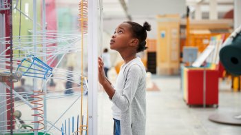 girl looking at exhibit at science museum