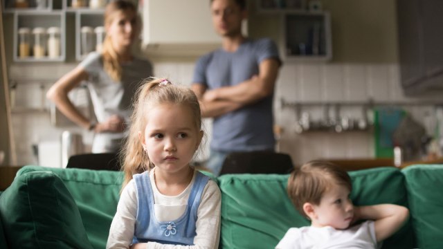 frustrated girl on couch with annoyed parents