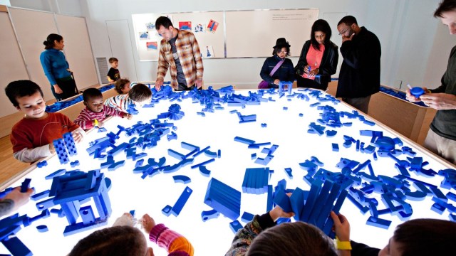 Families play with building blocks at the National Building Museum indoor playgrounds dc