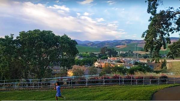 Sweeping views of Napa Valley at Meritage Resort and spa with a girl running in the foreground