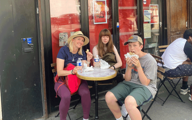 family in Paris, France enjoying crepes on food tour
