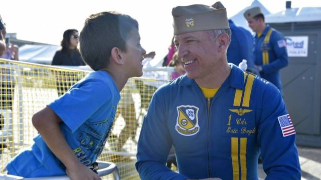 a blue angel show pilot and a boy are both smiling in seattle