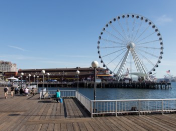 The Great Wheel looms over the Seattle waterfront on a sunny day