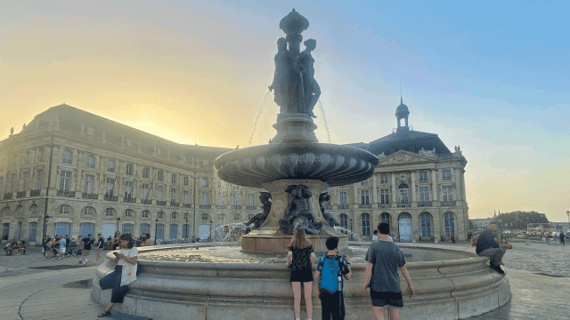 kids standing in front of Bordeaux's Place de la Bourse fountain