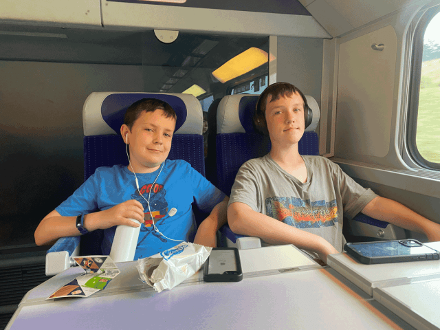 two kids sitting on train in bordeaux