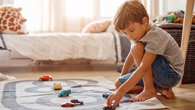 little boy playing with cars, which is a fun indoor summer activity