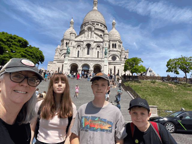 family standing in front of Sacre Coeur in Paris France
