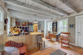 a kitchen is filled with morning light in a cabin near boston you can rent