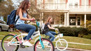 girls riding bikes together